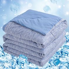 four blankets stacked on top of each other in front of some ice crystals and snow flakes