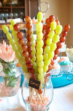 there is a vase filled with candy and candies on top of a white table