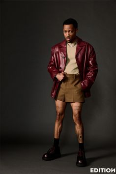 a man in shorts and a leather jacket