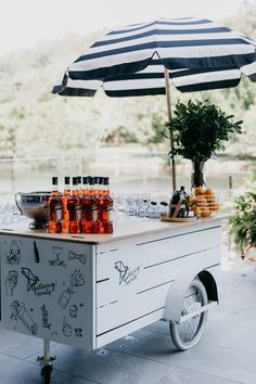 an outdoor bar cart with drinks on it