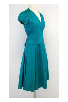 Size X-Small Deep Teal Wrap Dress Body 100% Silk Made in the USA Cap sleeves with elastic detail V neck Hits below the knee Wrap and tie waist for adjustable fit Underarm to underarm 18" Total length 42.5" Fitted A-line Wrap Dress With Tie Waist, Blue V-neck Wrap Dress With Tie Waist, Spring Dresses With Tie Waist And Stretch Fit, Cotton Fitted Dress With Gathered Waist, Spring Stretch Dress With Tie Waist, Fitted Cotton Dress With Gathered Waist, Spring Fitted Dress With Tie Fastening, Fitted Spring Dress With Tie Fastening, Fitted Dress With Tie Fastening For Spring