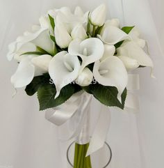 a bouquet of white flowers in a glass vase