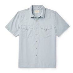 Hot days on the range call for the versatile Short-Sleeve Snap-Front Shirt. Built with a 2.6-oz. polyester and nylon blend it’s keeps you cool and provides UPF50 sun protection. The ultralight fabric wicks moisture away from you skin and has antimicrobial properties. Features Western-style front and back yokes and a snap-front closure. Straight hem with side vents. | Filson Short Sleeve Snap Front Shirt Blue Stone Size XS Fitted Short Sleeve Shirt With Pockets For Summer, Spring Outdoor Cotton Shirt, Fitted Summer Tops For Outdoor, Fitted Tops For Summer Outdoor, Fitted Camp Shirt With Pockets For Summer, Fitted Summer Camp Shirt With Pockets, Summer Outdoor Button-up Short Sleeve Shirt, Summer Outdoor Short Sleeve Button-up Shirt, Camp Collar Tops For Outdoor Spring Events