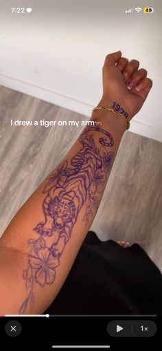 a person with a tiger tattoo on their arm and the words i draw a tiger on my arm