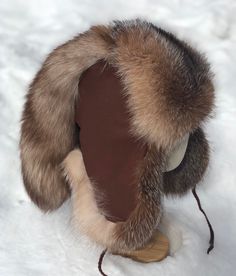 This is a beautiful hat that is made from soft and dense Crystal Fox fur on your choice of select Buckskin Leather. The liner is a quilted polyester and your choice of braided leather ties or paracord with cinch clip. Fox Tail Keychain, Cinch Clip, Trapper Hat, Hat Custom, Trapper Hats, Silver Fox, Beautiful Hats, Braided Leather, Fox Fur