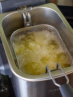 a large metal sink filled with yellow liquid