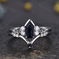 a diamond and blue sapphire engagement ring set on top of a granite slab with the words i love you above it