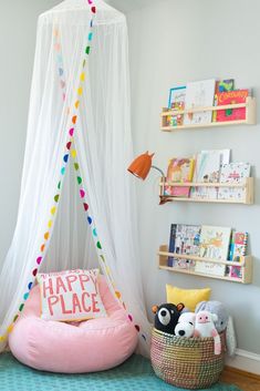 a room with a bed, bookshelf and stuffed animals