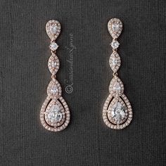 A layered pave design surrounds teardrop and marquise cubic zirconia stones in these beautiful special occasion earrings. They are 2 inches long and 5/8 of an inch wide, post backs. Available in rhodium, rose gold, or gold plate, AAA grade CZ, lead, nickel and cadmium free. Matching pendant necklace here. Gold Bride Earrings, 2 Layer Necklace, Gold Bridal Hair Accessories, Quinceanera Jewelry, Bridal Jewelry Vintage, Pipe Dream, Bride Earrings, Bridesmaid Accessories, Bridesmaid Jewelry Sets