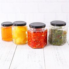 four jars filled with different types of food