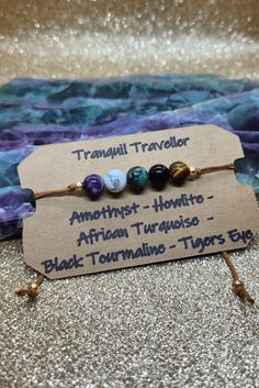 Make your travels a bit less stressful and overwhelming or conquer your fears with this fully adjustable Tranquil Traveller sliding knot adjustable bracelet Amethyst creates a sense of peace and calm during your travels and supports you in relaxing as you adjust to your new destination  Howlite supports safe travel as well as stress relief and patience  African Turquoise assists in finding your voice during travel to ask for directions or assistance during your travels Black Tourmaline a grounding and protective shield during your travels  Tigers Eye provides strength and courage during your travels Wire Wrapping Beads, Finding Your Voice, Lava Stone Jewelry, Conquer Your Fears, Jar Spells, Spiritual Crystals, Wrist Candy, Wire Jewelry Designs, African Turquoise