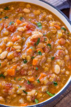 a bowl of soup with beans and carrots