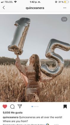 a woman in a dress holding up two large silver balloons that say 35 and the number fifty five