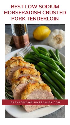 the best low - sodomm horseradish crusted pork tenderloin on a white plate with green beans and lemons