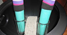 two pairs of colorful socks sitting in a black container