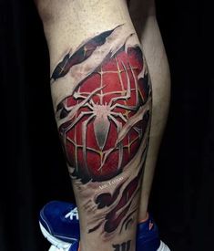 a spiderman tattoo on the leg of a man's leg with red and black ink