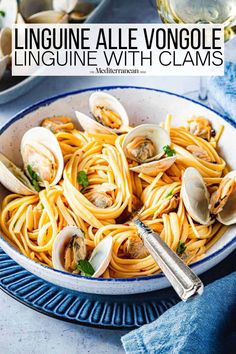 linguinne with clams in a white bowl on a blue and white plate