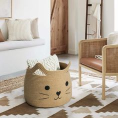 a cat shaped basket sitting on top of a rug