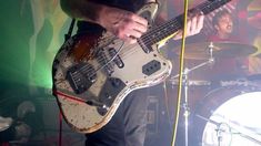 a man playing an electric guitar on stage