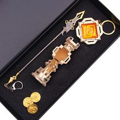 an assortment of items in a black box on a white surface with keychains