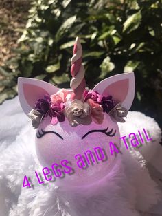 a pink unicorn head with flowers on it