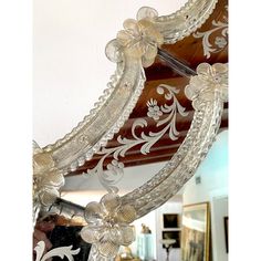 an ornately decorated mirror hanging from the ceiling