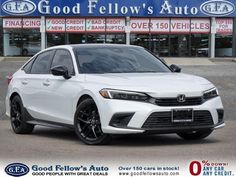 a white car that is parked in front of a dealership with the words good fellow's auto written on it