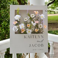 a wedding sign with flowers on it