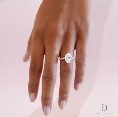 a woman's hand with a diamond ring on it