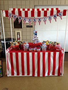 a red and white table topped with lots of candy