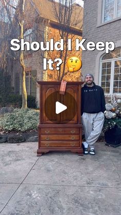 a man standing in front of a wooden cabinet with the words should i keep it?