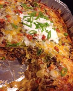 a close up of a pizza in a pan with toppings on the top and one slice missing