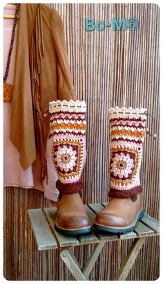 a pair of brown boots with crochet on them