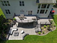 an aerial view of a house with patio and decking area in the middle of it