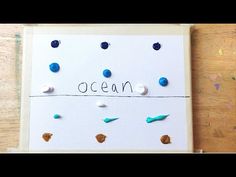 a piece of paper with writing on it and some sea shells attached to the board