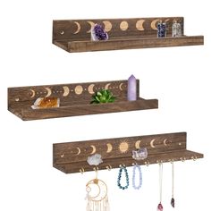 three wooden shelves with jewelry hanging from the top and bottom, each holding different items