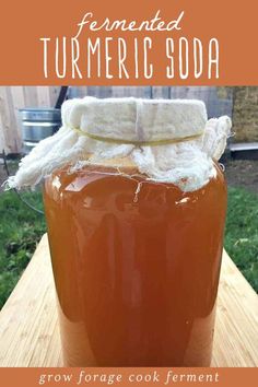 homemade fermented turmeric soda in a mason jar on a wooden table