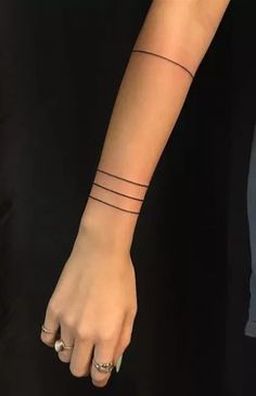 a woman's arm with two small lines on it and a ring in the middle