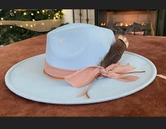 Blue Skies- light blue hat adorned with ribbon and a large turkey feather! Adorable hat! One size fits most! Hand wash only, lint brush for dusting Adjustable Blue Hat Bands For Fall, Adjustable Light Blue Winter Hat, Blue Western Style Winter Hat, Blue Adjustable Hat With Feather Trim, Adjustable Blue Hat With Feather Trim, Lsu Game, Mens Hats Fashion, Womens Hats, Lint Brush