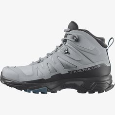 a pair of grey hiking boots on a white background