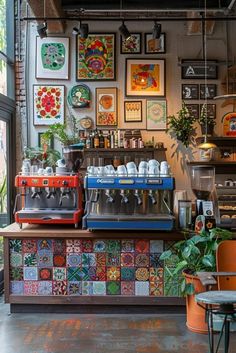 a coffee shop with lots of art on the wall and pictures hanging up above it