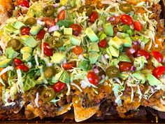 a tray filled with nachos and toppings on top of eachother