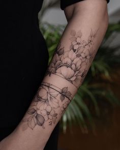 a woman with a flower tattoo on her arm