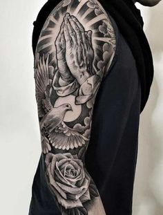 a man's arm with a dove and roses tattoo on it