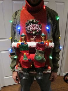 a man is dressed up as a christmas stocking holder with stockings and lights on his feet