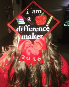 a girl wearing a graduation cap with the words i am a difference maker on it