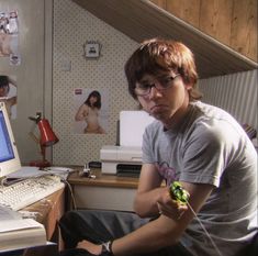 a young man sitting in front of a computer