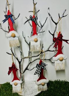 a christmas tree with ornaments hanging from it's branches and decorations on the top