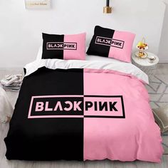 black pink and white bedding with matching pillows in a bedroom setting on the floor