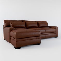 a brown leather sectional sofa sitting on top of a white floor